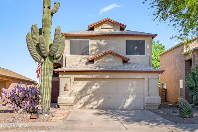 8014 S Wild Primrose Ave, Tucson, AZ 85747 - view of front of home featuring an attached garage, driveway, roof with shingles, and stucco siding