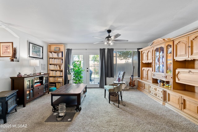 8014 S Wild Primrose Ave, Tucson, AZ 85747 - living area with ceiling fan, light carpet, french doors, and a wood stove