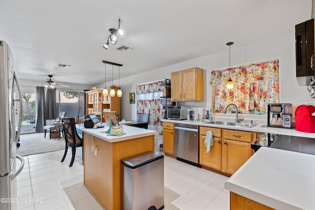 8014 S Wild Primrose Ave, Tucson, AZ 85747 - kitchen with appliances with stainless steel finishes, pendant lighting, a sink, and visible vents