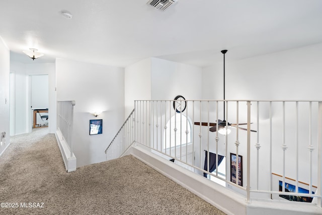 8014 S Wild Primrose Ave, Tucson, AZ 85747 - hall featuring carpet floors, baseboards, an upstairs landing, and visible vents