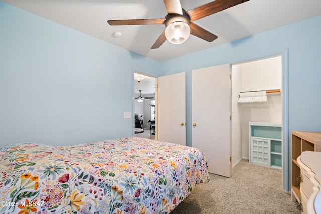 8014 S Wild Primrose Ave, Tucson, AZ 85747 - bedroom with a walk in closet, ceiling fan, light carpet, and a closet