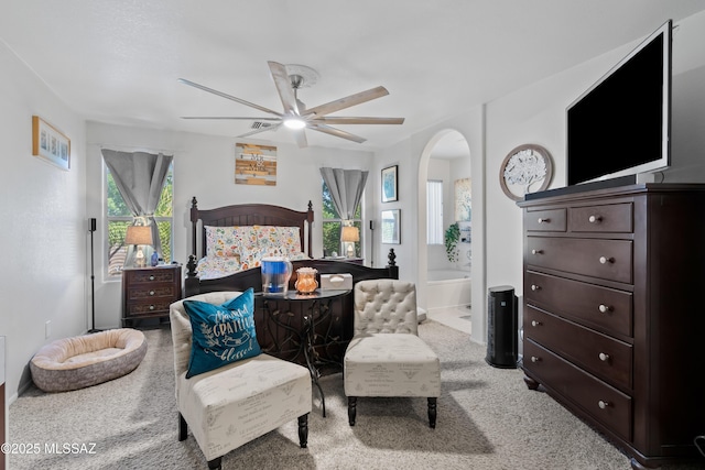 8014 S Wild Primrose Ave, Tucson, AZ 85747 - bedroom featuring arched walkways, a ceiling fan, light colored carpet, and ensuite bath