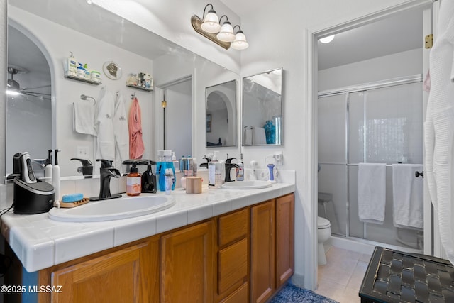8014 S Wild Primrose Ave, Tucson, AZ 85747 - bathroom featuring double vanity, tile patterned floors, a sink, and a stall shower
