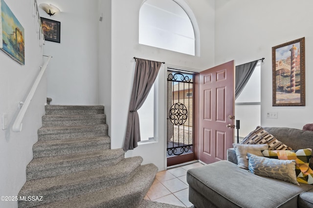 8014 S Wild Primrose Ave, Tucson, AZ 85747 - entrance foyer with tile patterned floors, stairway, and a towering ceiling