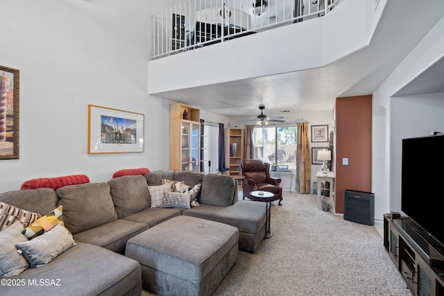 8014 S Wild Primrose Ave, Tucson, AZ 85747 - living area with ceiling fan, light carpet, and a towering ceiling