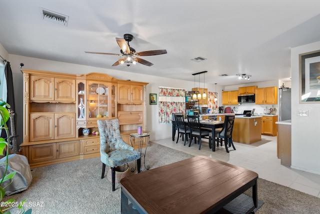 8014 S Wild Primrose Ave, Tucson, AZ 85747 - living area featuring a ceiling fan, visible vents, and light tile patterned floors