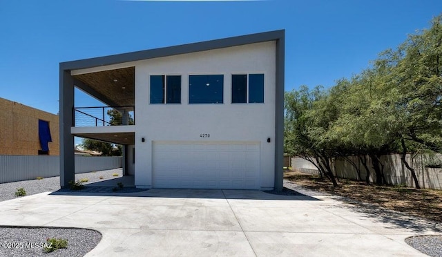 4270 E Broadway Blvd, Tucson, AZ 85711 - view of front of property with a garage, fence, driveway, and a balcony