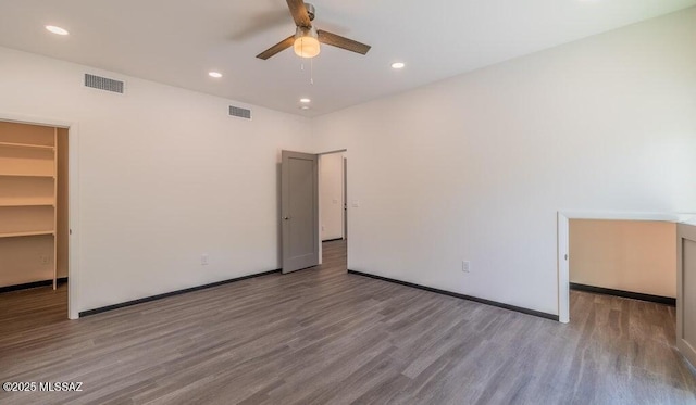4270 E Broadway Blvd, Tucson, AZ 85711 - unfurnished bedroom with a spacious closet, recessed lighting, wood finished floors, and visible vents