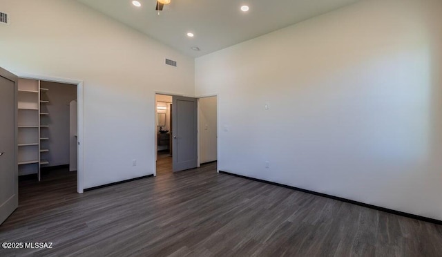 4270 E Broadway Blvd, Tucson, AZ 85711 - unfurnished bedroom with baseboards, dark wood-style floors, and visible vents