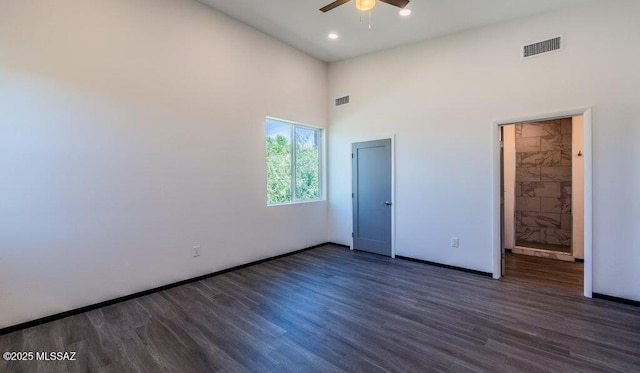 4270 E Broadway Blvd, Tucson, AZ 85711 - unfurnished bedroom featuring a towering ceiling, wood finished floors, and visible vents