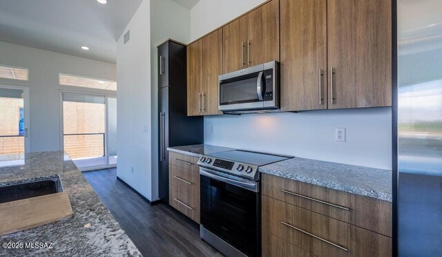 4270 E Broadway Blvd, Tucson, AZ 85711 - kitchen featuring stone countertops, stainless steel appliances, recessed lighting, visible vents, and dark wood-style floors