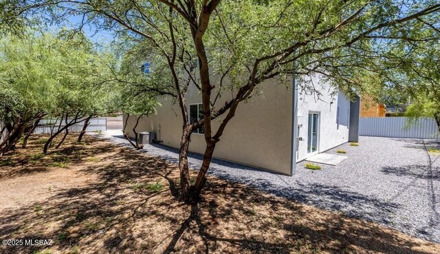 4270 E Broadway Blvd, Tucson, AZ 85711 - view of property exterior with fence, a patio area, and stucco siding