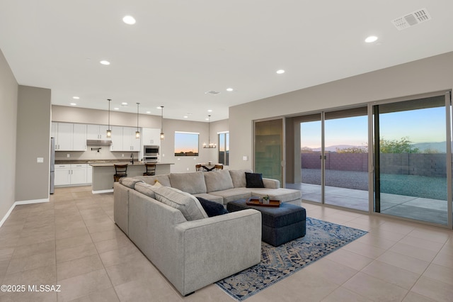 living area featuring recessed lighting, baseboards, visible vents, and light tile patterned floors