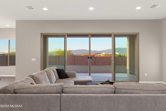 living room with recessed lighting, a mountain view, and visible vents
