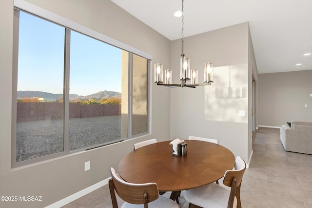 dining area featuring an inviting chandelier, recessed lighting, baseboards, light tile patterned floors, and a mountain view