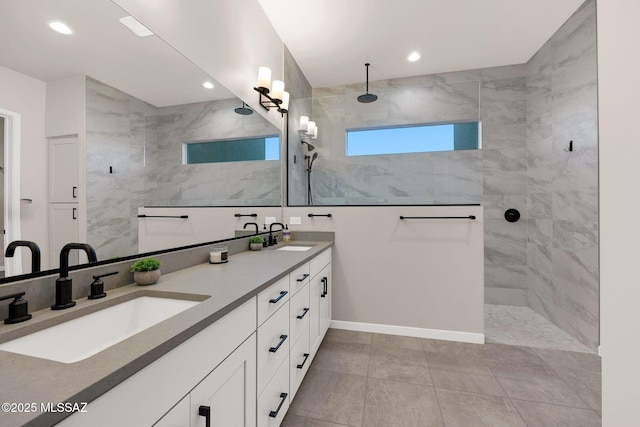 full bath featuring double vanity, walk in shower, a sink, and recessed lighting