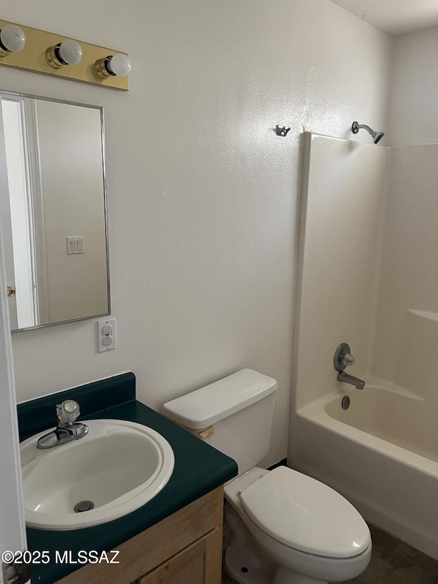bathroom with toilet, washtub / shower combination, and vanity