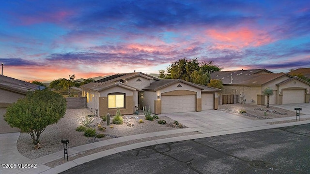 single story home with fence, stucco siding, an attached garage, driveway, and a tile roof