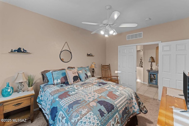bedroom with a ceiling fan, light tile patterned flooring, and visible vents