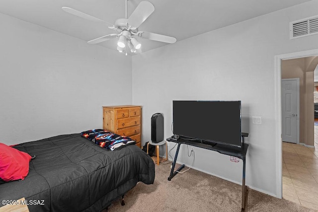 tiled bedroom with visible vents, carpet floors, baseboards, ceiling fan, and arched walkways