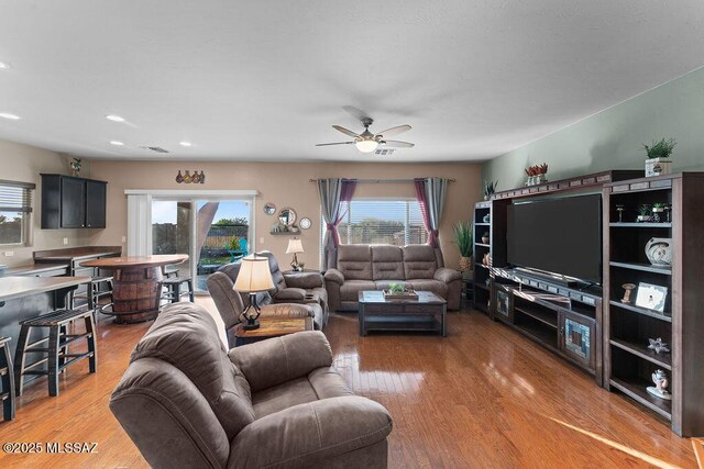 living room with recessed lighting, a ceiling fan, and light wood finished floors