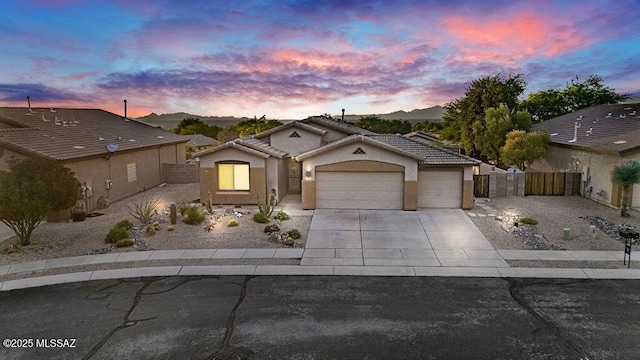 single story home with a tile roof, fence, concrete driveway, an attached garage, and stucco siding