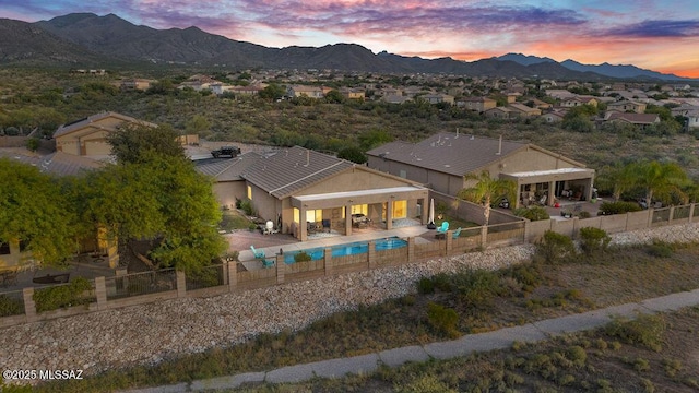exterior space featuring a fenced in pool, a fenced backyard, and a mountain view