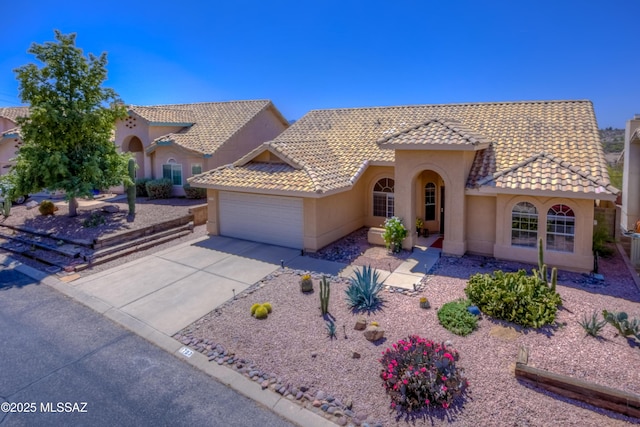 1707 W Sunridge Dr, Tucson, AZ 85704 - mediterranean / spanish home featuring a garage, stucco siding, concrete driveway, and a tile roof