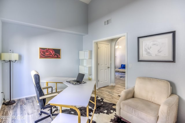 1707 W Sunridge Dr, Tucson, AZ 85704 - home office featuring baseboards, high vaulted ceiling, visible vents, and wood finished floors