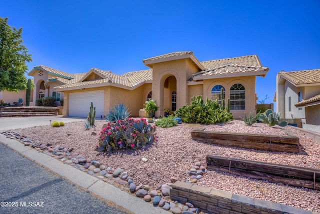 1707 W Sunridge Dr, Tucson, AZ 85704 - mediterranean / spanish-style home featuring stucco siding, an attached garage, driveway, and a tile roof