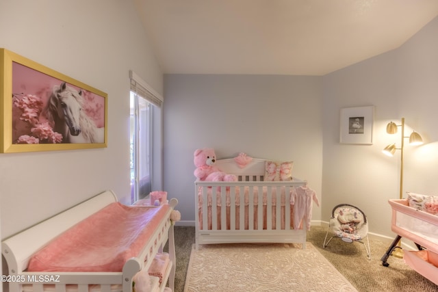 1707 W Sunridge Dr, Tucson, AZ 85704 - bedroom featuring baseboards, vaulted ceiling, a crib, and carpet