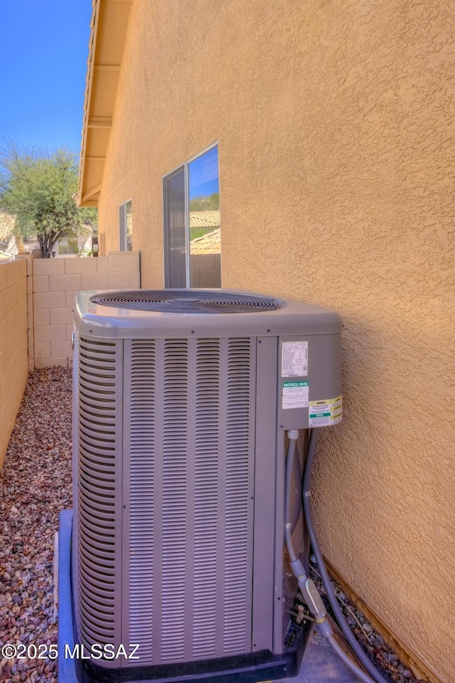 1707 W Sunridge Dr, Tucson, AZ 85704 - details with fence, stucco siding, and cooling unit