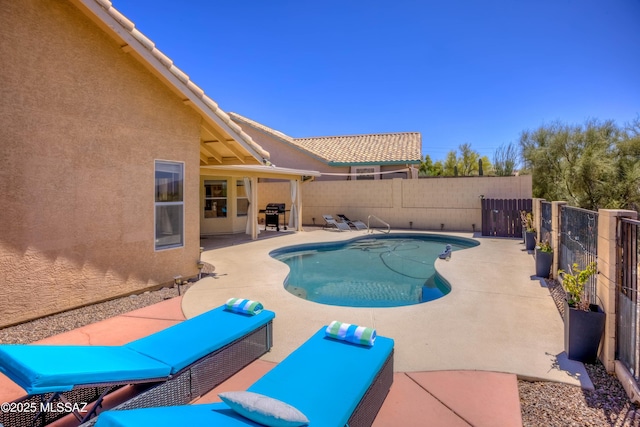 1707 W Sunridge Dr, Tucson, AZ 85704 - view of swimming pool with a patio, a fenced backyard, a fenced in pool, and area for grilling