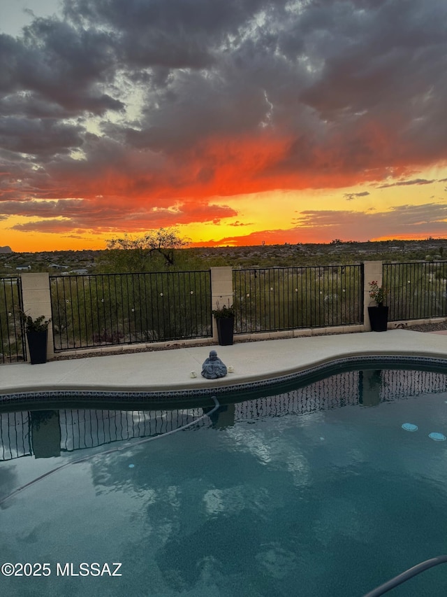 1707 W Sunridge Dr, Tucson, AZ 85704 - pool at dusk with a fenced in pool