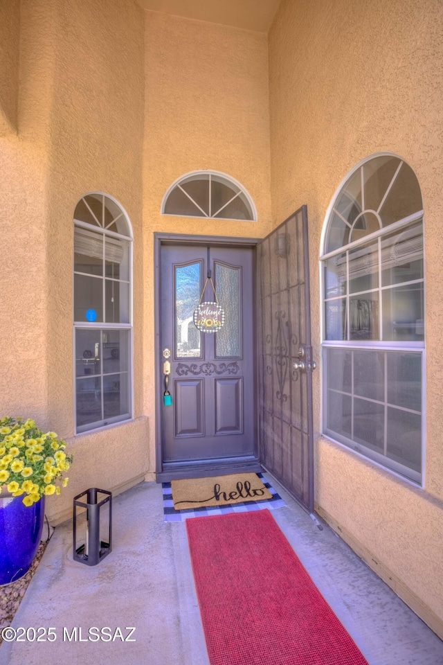 1707 W Sunridge Dr, Tucson, AZ 85704 - property entrance with a porch and stucco siding