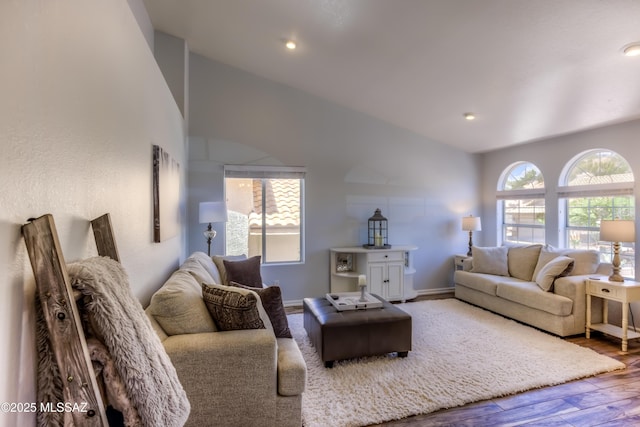 1707 W Sunridge Dr, Tucson, AZ 85704 - living room with baseboards, vaulted ceiling, and wood finished floors