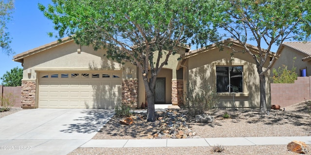 view of front of property with a garage, fence, concrete driveway, stone siding, and stucco siding