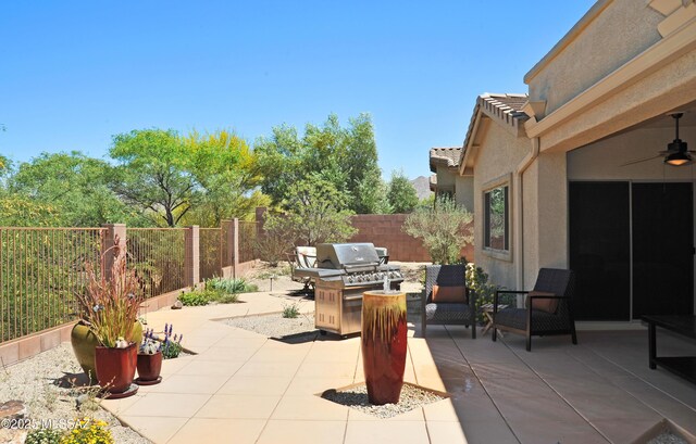 view of patio / terrace featuring grilling area, a ceiling fan, and a fenced backyard