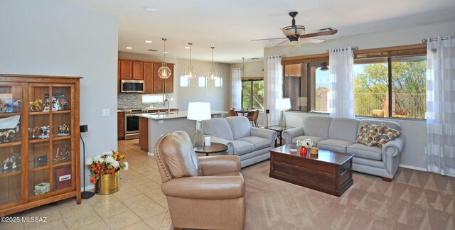 living area featuring light tile patterned floors, a ceiling fan, and recessed lighting