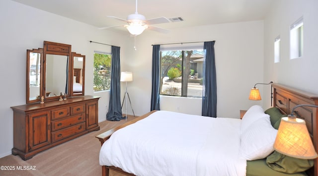 bedroom with visible vents and light colored carpet