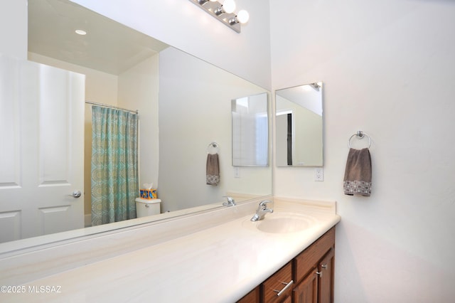bathroom featuring vanity, a shower with curtain, and toilet