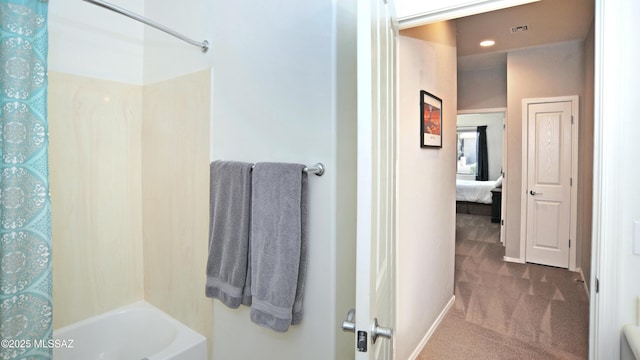 ensuite bathroom with recessed lighting, baseboards, ensuite bathroom, and shower / bathtub combination
