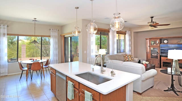 kitchen featuring a sink, a wealth of natural light, open floor plan, and light countertops