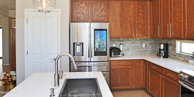 kitchen featuring backsplash, stainless steel appliances, brown cabinets, and pendant lighting