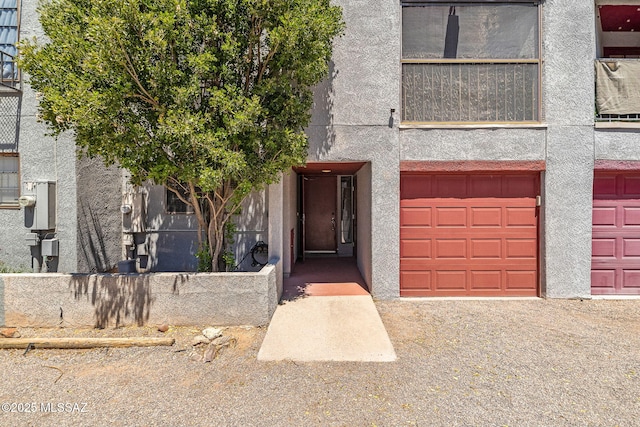 1525 N Bryant Ave, Tucson, AZ 85712 - doorway to property featuring a garage and stucco siding