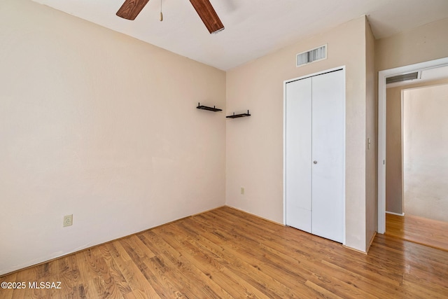 1525 N Bryant Ave, Tucson, AZ 85712 - unfurnished bedroom with a ceiling fan, visible vents, wood finished floors, and a closet