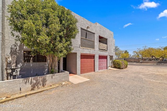 1525 N Bryant Ave, Tucson, AZ 85712 - view of building exterior featuring an attached garage and driveway