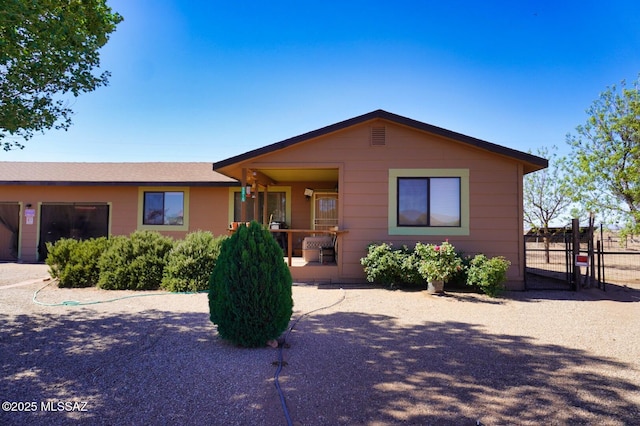 view of front of home with fence and a gate