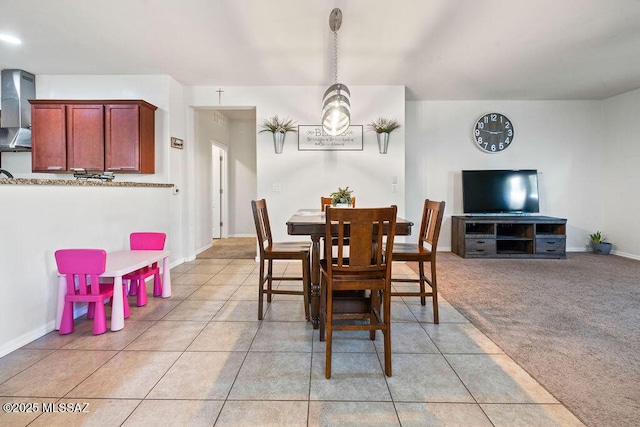 dining room with light tile patterned flooring and baseboards