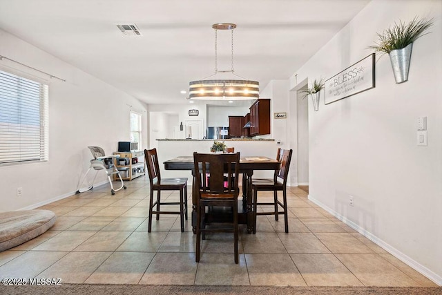 dining space featuring visible vents, baseboards, and light tile patterned flooring